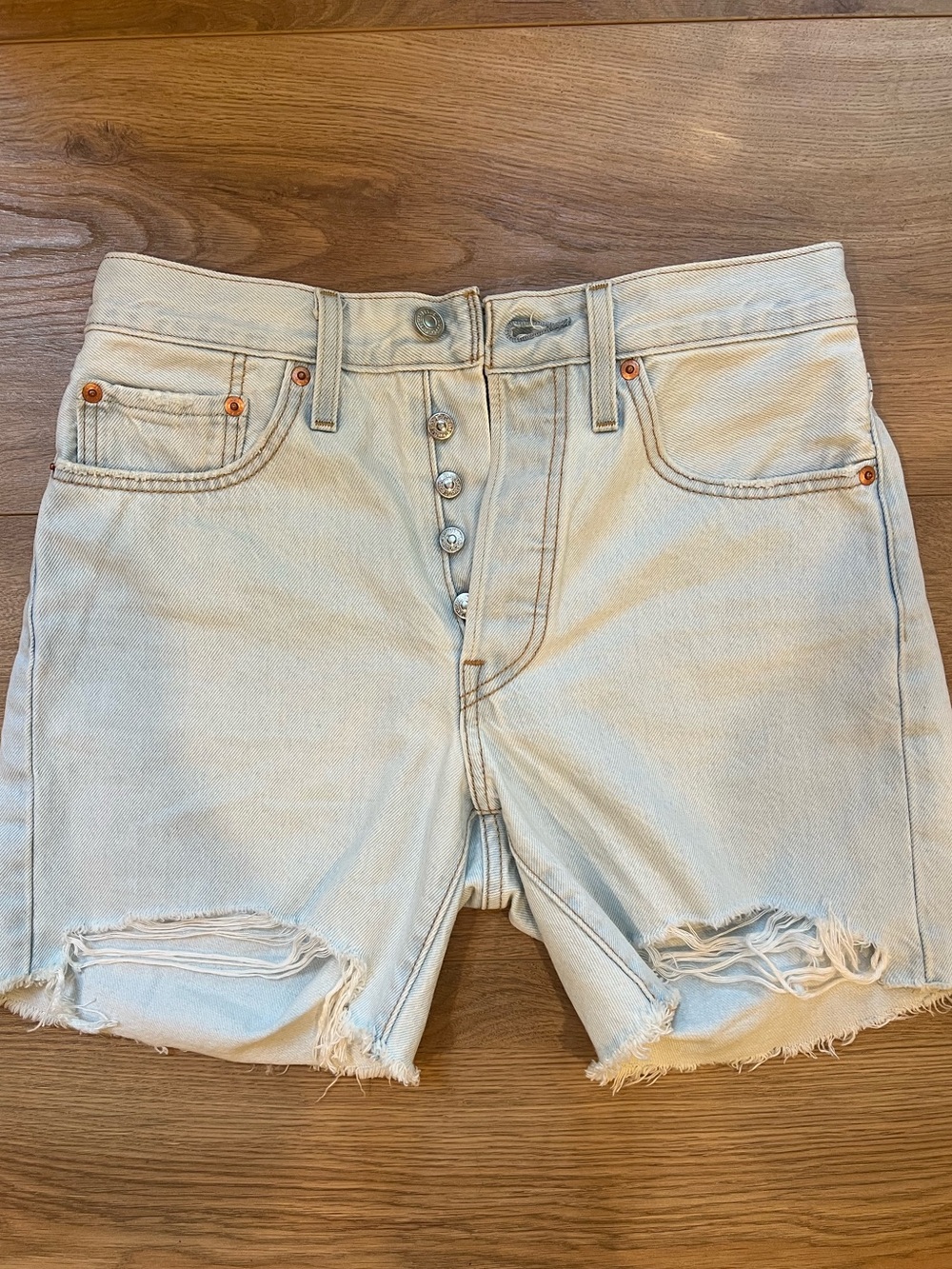 New, without tags- Levi's 501 Light Blue Button-Front Distressed Denim Shorts.